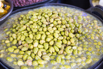 A lot of fresh green olives in a bowl