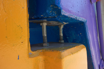 Bolts in between yellow and blue objects