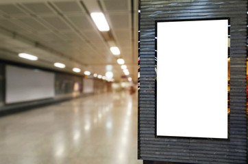 blank billboard or advertising light box for your text message or media content with blurred image of walkway in subway at railway station, transportation, commercial and marketing concept