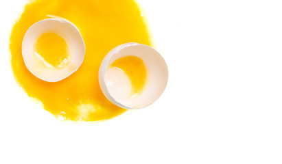 Broken egg yolk on white background isolation