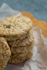 Oatmeal cookies and milk on a wooden board and gray background