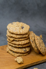 Oatmeal cookies and milk on a wooden board and gray background