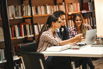 Group of female students study in the school library.Learning and preparing for university exam.Education concept.