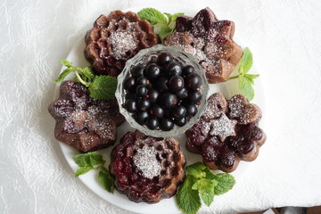 muffin and currant berries on white background