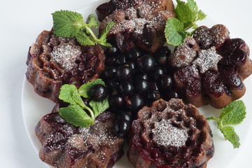 muffin and currant berries on white background