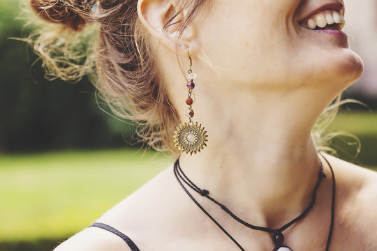 Woman wearing decorative long earrings