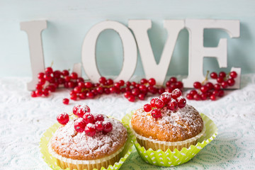 A word of love and a mini dessert on a light background.