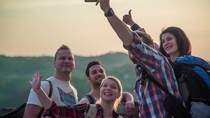 Happy young tourists are taking a photo together on the castle's balcony. The day is really sunny and beautiful.