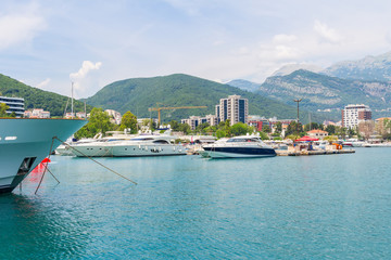 View to the city Budva at Adriatic sea coastline and marine harbor with yachts in the foreground, Montenegro. summer seascape background