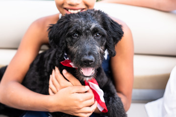 Girl holding Australian shepherd puppy