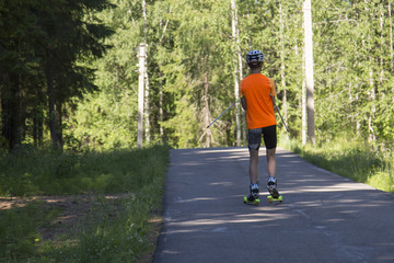 Man cross-country skiing with roller ski