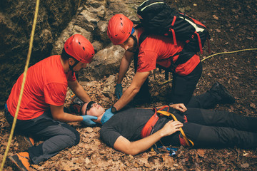 Search and rescue team helping injured alpinist 