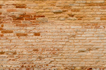 Old and damaged brown brick wall