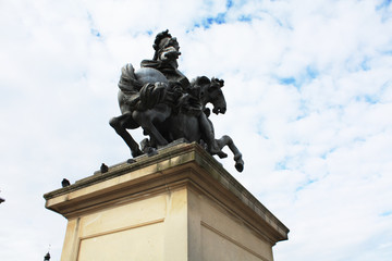 Fototapeta na wymiar Paris / France - February 10 2013. King Louis XIV on horse sculpture in Paris. Building Louvre museum. French architecture. 