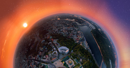 A big 180 degrees panorama of the city of Kiev over the St. Michael's Golden-Domed Monastery at sunset and starry sky. A modern metropolis in the center of Europe against the backdrop of sunset sky
