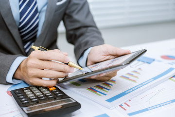 Business man looking at business document in touchpad