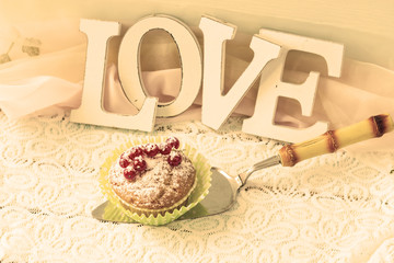 A word of love and a mini dessert on a light background.
