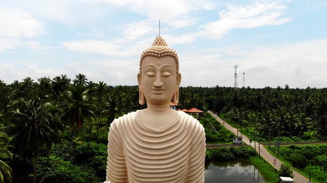 Aerial view from shot Peraliya Buddha Statue, the Tsunami Memorial in Hikkaduwa, Sri Lanka 4k
