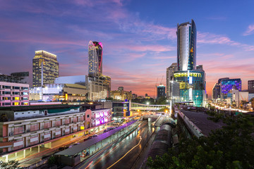 Cityscape view of Pratunam, famous shopping landmark in Bangkok, Thailand at sunset time and boat...