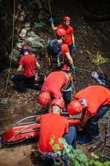 Search and rescue team helping injured alpinist 