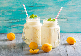 smoothies apricot yogurt  delicate wooden background
