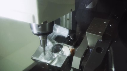 The CNC milling machine cutting the aluminium automotive part with the solid. Modern manufacturing process - Powered by Adobe