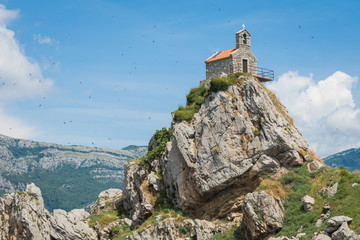 View of beautiful islets Katic (Katich) and Sveta Nedjelja with church on one of them in the sea near Petrovac, Montenegro.