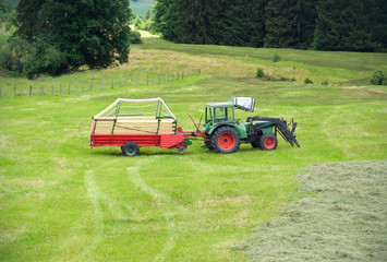 Parking tractor for gather the dry grass so it can be used as animal fodder for cows