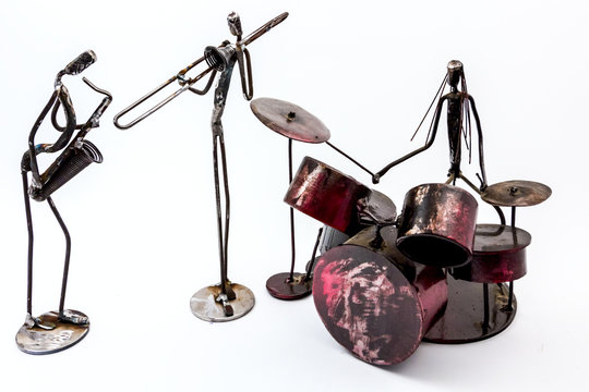 Creative figures of musicians, saxophone, drummer and trumpet are playing together