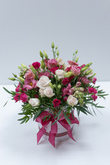 Bouquet festive with pink and red roses in a pink gift box