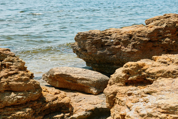 Fototapeta na wymiar stones on the beach, beautiful sea summer landscape, wild beach closeup