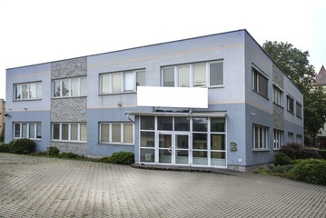 Building with the blank sign for company name.