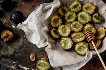 Fresh and ripe sliced plums. Metal background