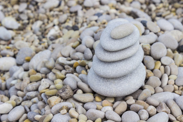 Pyramid of gray pebbles on the beach, Zen sculpture