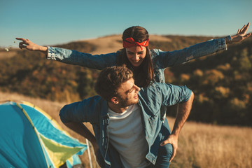 Happy young couple enjoys a sunny day in nature