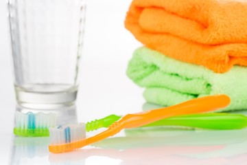 Toothbrushes, Towel and a Glass