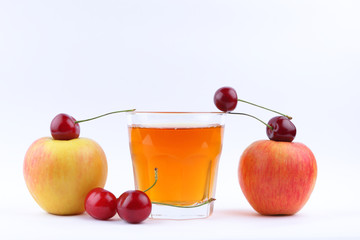 Juice with apples and cherries, fresh apple juice on white background, healthy lifestyle, vegetarian drink, red berries with other fruits