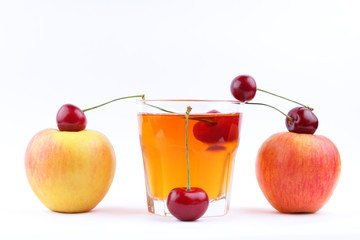 Juice with apples and cherries, fresh apple juice on white background, healthy lifestyle, vegetarian drink, red berries with other fruits