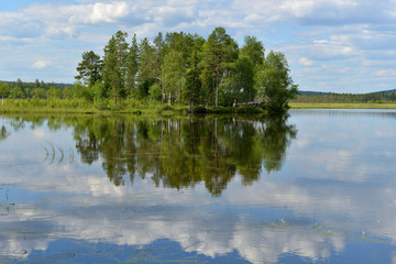 Northern landscape. Lake with reflection of clouds. Finnish Lapland