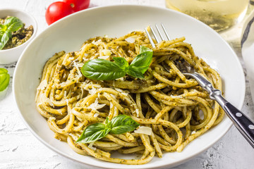 Spaghetti with homemade pesto sauce on a white background. selective focus
