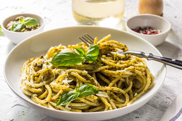 Spaghetti with homemade pesto sauce on a white background. selective focus