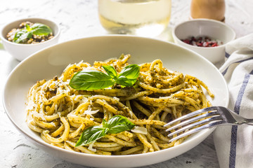 Spaghetti with homemade pesto sauce on a white background. selective focus