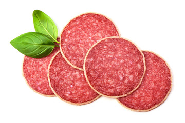 Salami with basil leaf. Smoked sausage thinly sliced, isolated on white background. Top view.