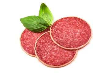 Salami with basil leaf. Smoked sausage thinly sliced, isolated on white background.