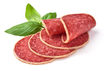Salami with basil leaf. Smoked sausage thinly sliced, isolated on white background.