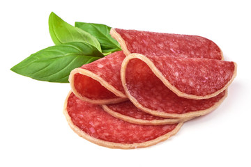 Salami with basil leaf. Smoked sausage thinly sliced, isolated on white background.