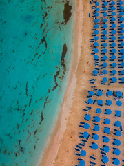 Makronissos beach from above - Light blue warm water, golden sand and blue umbrellas under the sun