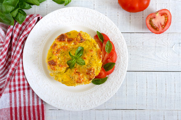 Tasty useful casserole from cauliflower on a plate on a white wooden background. Vegetarian menu. Proper nutrition.