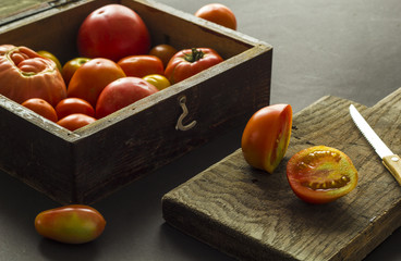 Cut tomatoes on a wooden board. 