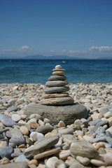 Fototapeta na wymiar Stone tower on a beach covered with pebble